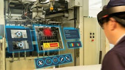 A maintenance worker wearing augmented reality glasses to assess a machine A maintenance worker wearing augmented reality glasses to assess a machine