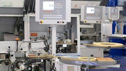 A close up view of manufacturing machinery with computer displays on which performance data can be viewed A close up view of manufacturing machinery with computer displays on which performance data can be viewed