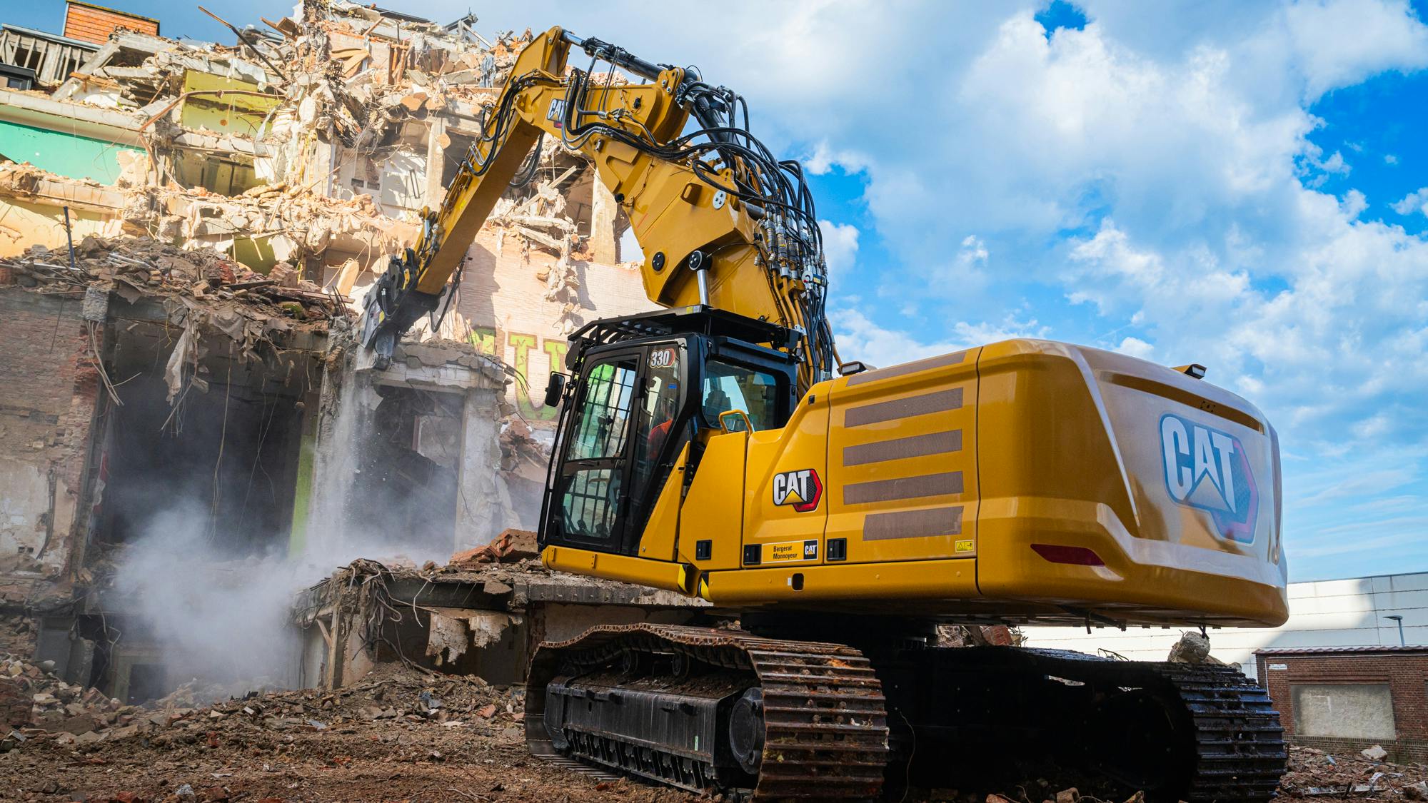 Caterpillar 330 UHD hydraulic excavator demolishing a building
