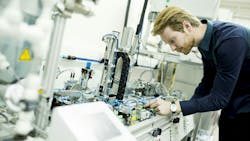 A man evaluates components in a manufacturing facility A man evaluates components in a manufacturing facility