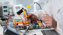 An engineer using various voltage detection and other tools to safely work on an electronics system An engineer using various voltage detection and other tools to safely work on an electronics system