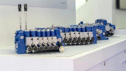 Several Husco MX hydraulic valves lined up next to each other Several Husco MX hydraulic valves lined up next to each other