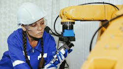 A woman changing a tool on a cobot A woman changing a tool on a cobot