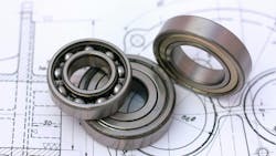 An image of three bearings on top of a design schematic An image of three bearings on top of a design schematic