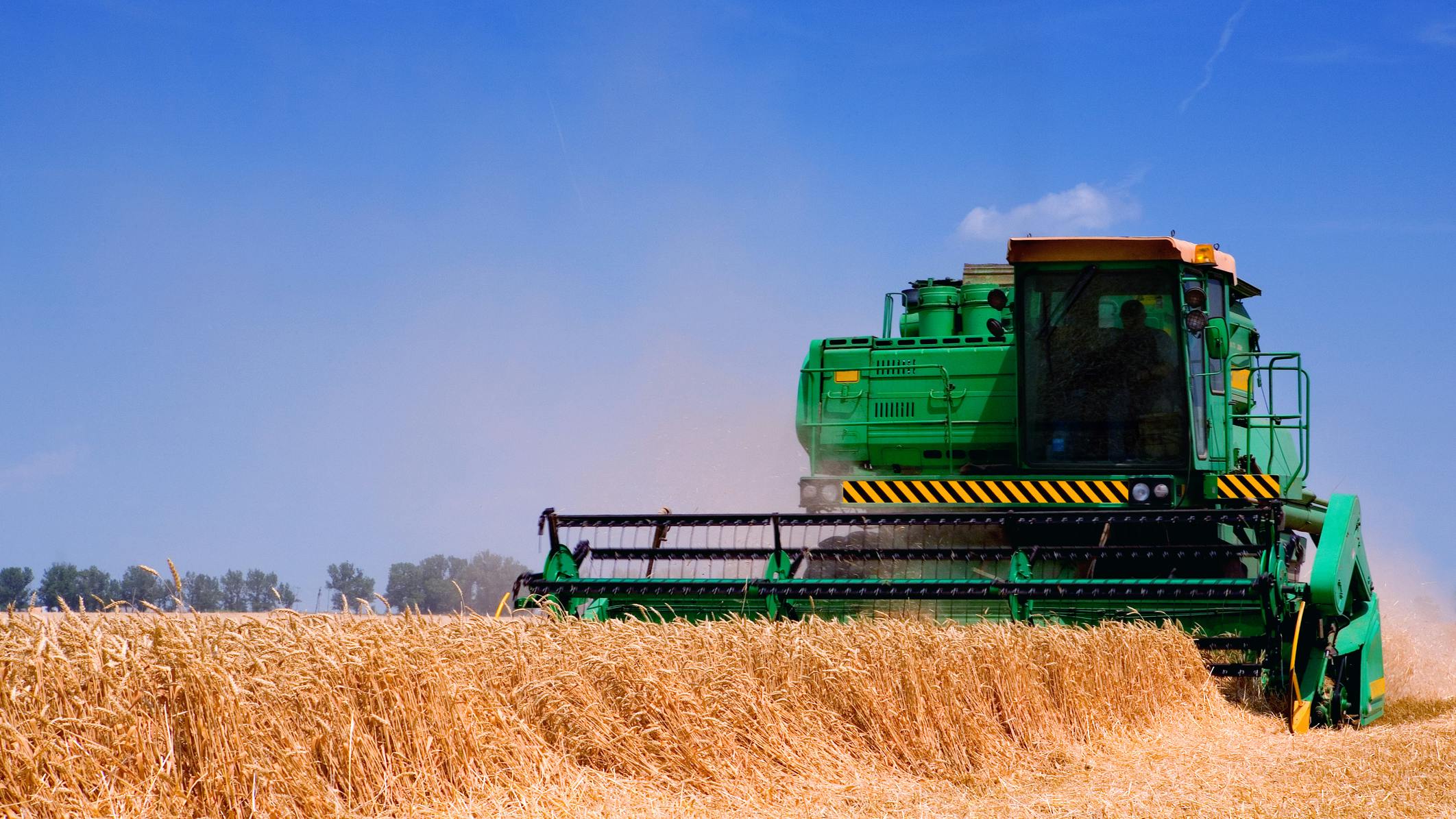 A combine working in a farm field
