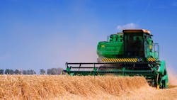 A combine working in a farm field A combine working in a farm field