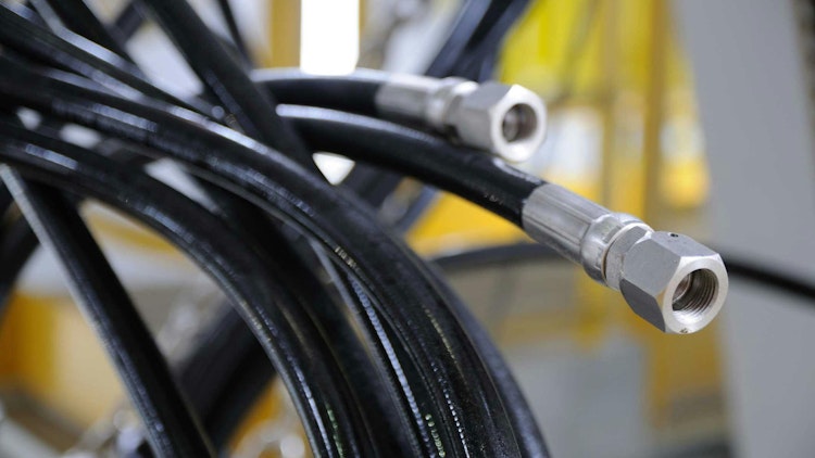 A close up image of several hydraulic hoses