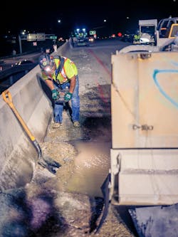 A construction worker remotely controlling machinery from a safe distance A construction worker remotely controlling machinery from a safe distance