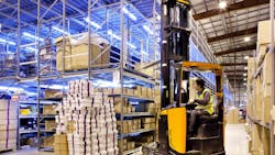 A forklift being operated in a warehouse A forklift being operated in a warehouse
