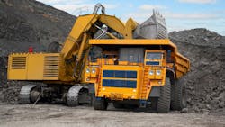 Mining shovel loading material into a mine truck at a quarry Mining shovel loading material into a mine truck at a quarry