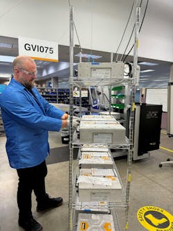 A Parker Hannifin engineer standing next to a stack of inverters used for traction and work function applications A Parker Hannifin engineer standing next to a stack of inverters used for traction and work function applications