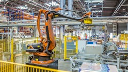 An industrial robot working in a production facility An industrial robot working in a production facility