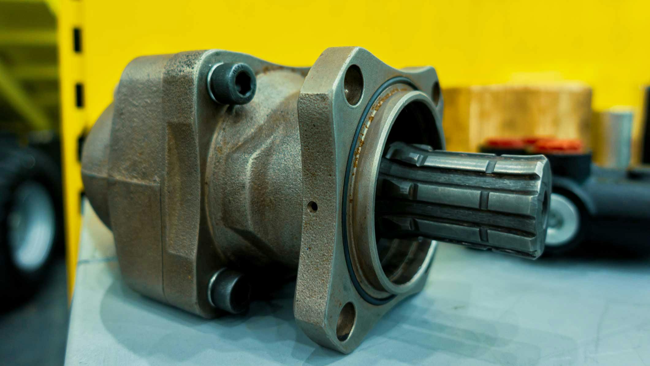 A hydraulic pump in front of a machine