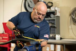 A PIRTEK technician servicing a hose at one of the company's service centers A PIRTEK technician servicing a hose at one of the company's service centers