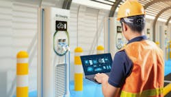 A technician standing in front of an electric vehicle charging station A technician standing in front of an electric vehicle charging station