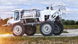 Agricultural sprayer driving on a road Agricultural sprayer driving on a road