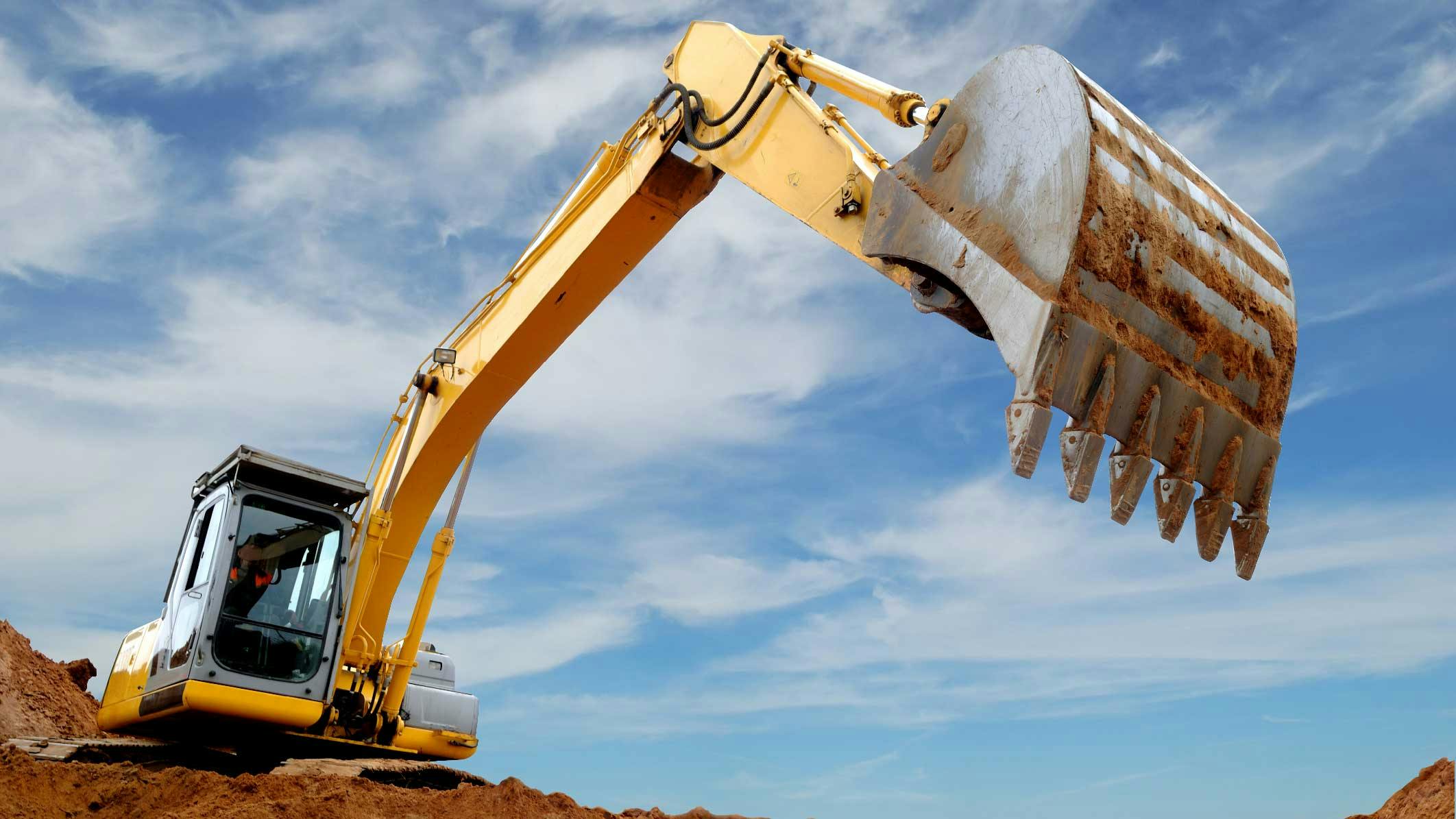 A view of the front of an excavator getting ready to dig dirt