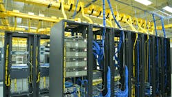 Data center racks with cables, hoses and other components visible Data center racks with cables, hoses and other components visible