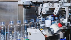Water bottles going down a production line Water bottles going down a production line