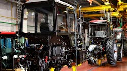 Tractors moving along an assembly line in a manufacturing facility Tractors moving along an assembly line in a manufacturing facility