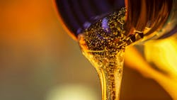 Stream of oil flowing out of a bottle Stream of oil flowing out of a bottle