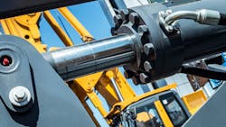 Close up of a hydraulic cylinder on a construction machine Close up of a hydraulic cylinder on a construction machine