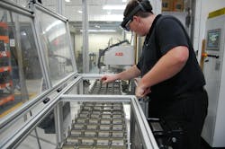 Former intern and now Parker Hannifin employee George Rak Working on a Robot Cell Former intern and now Parker Hannifin employee George Rak Working on a Robot Cell
