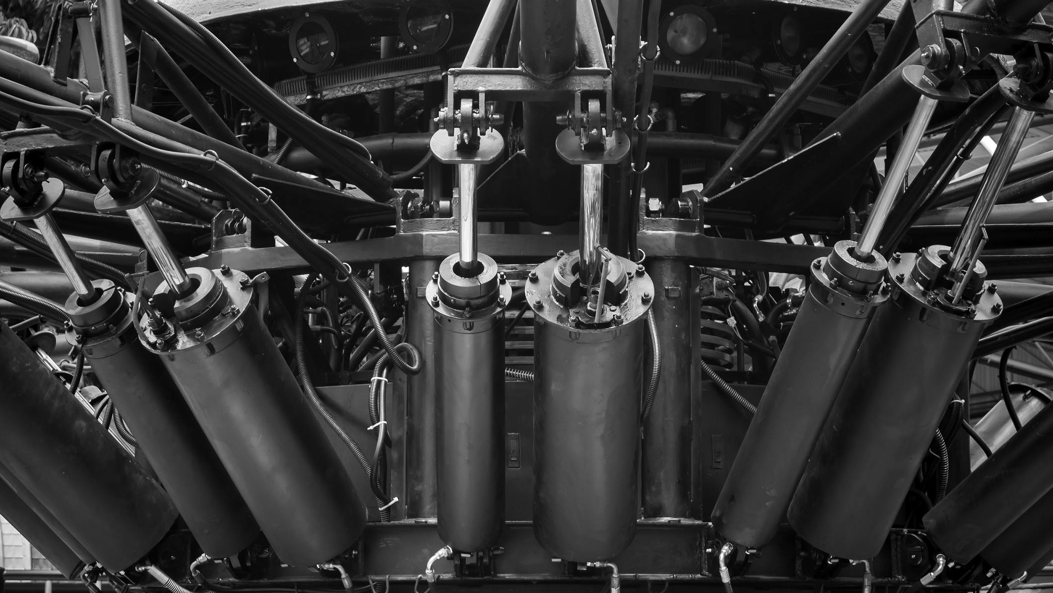 Underside view of a machine and several hydraulic cylinders installed on it