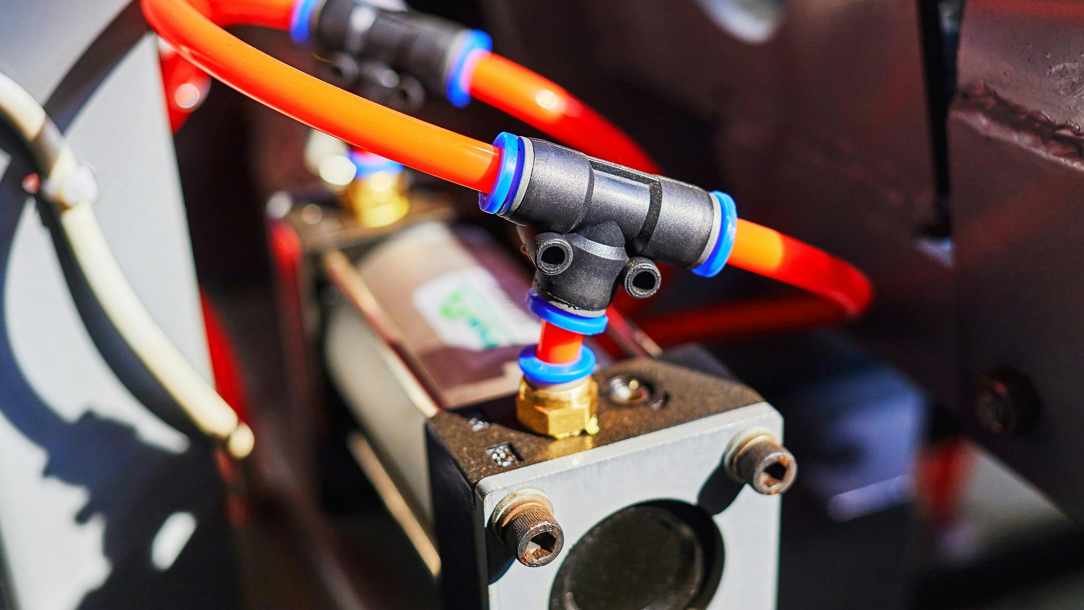 Pneumatic cylinder and tubing installed on an industrial machine