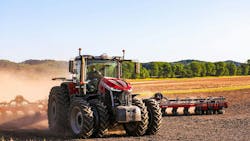 AGCO tractor pulling an implement through a farm field AGCO tractor pulling an implement through a farm field