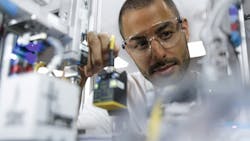 A man placing a component as part of Industry 4.0 training provided by Festo Didactic A man placing a component as part of Industry 4.0 training provided by Festo Didactic