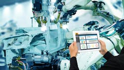 Industry 4.0 concept with hands holding a tablet in front of a robot assembling a vehicle Industry 4.0 concept with hands holding a tablet in front of a robot assembling a vehicle