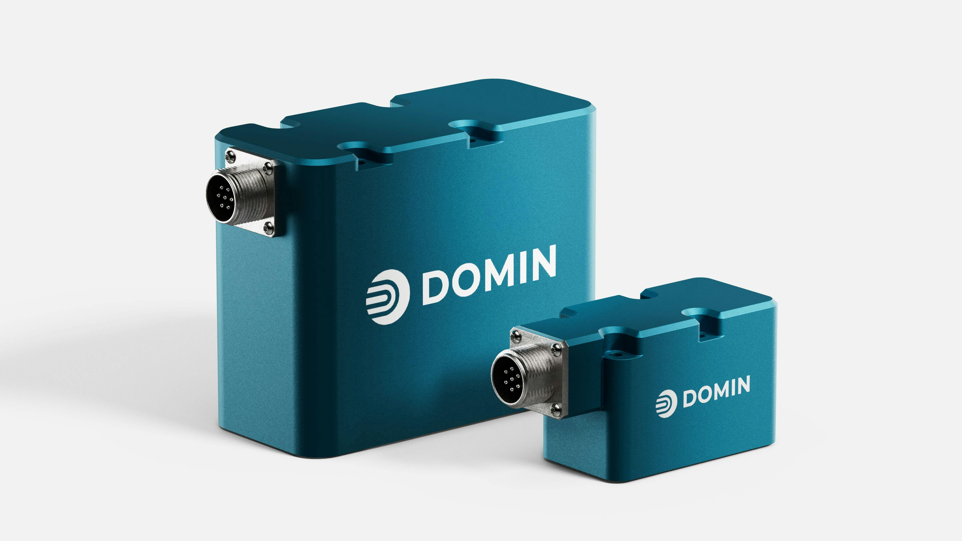Two Domin P Series servo proportional valves sitting next to each other on a white backdrop