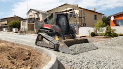 Compact track loader working on a construction site Compact track loader working on a construction site