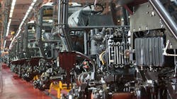 Tractors moving down a production line at a factory Tractors moving down a production line at a factory