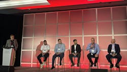 Members of fluid power industry sitting on a stage Members of fluid power industry sitting on a stage