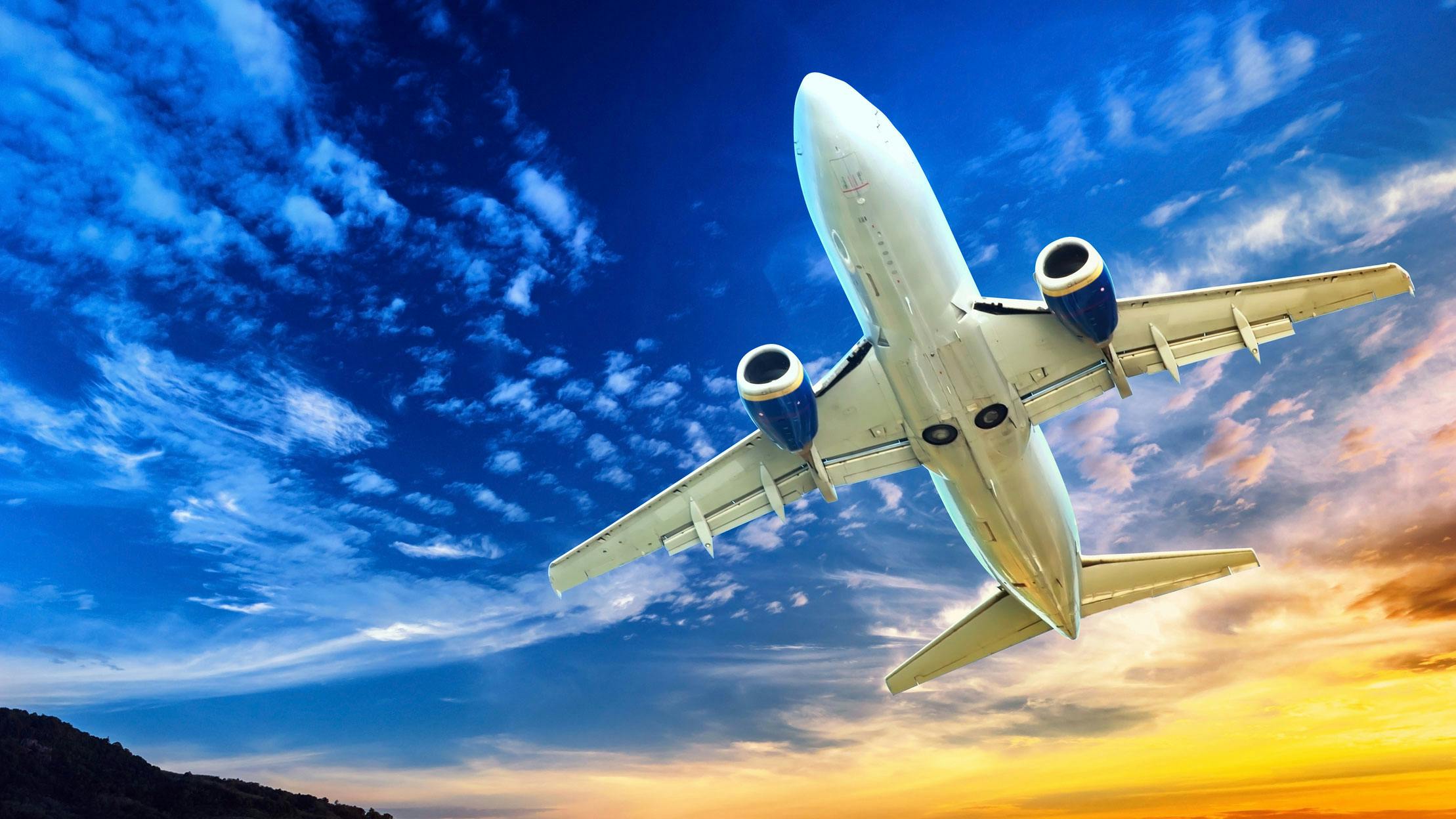 Underside view of an airplane flying in the sky