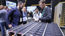 Two men talking over electrification-related technology at CONEXPO Two men talking over electrification-related technology at CONEXPO