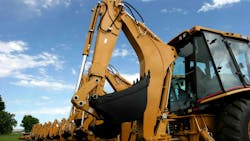 Backside view of several backhoes lined up Backside view of several backhoes lined up