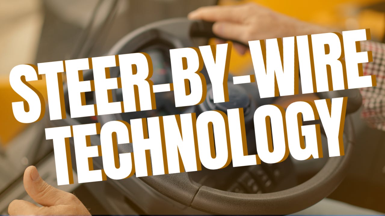 Hands on steering wheel overlaid with the words steer-by-wire technology