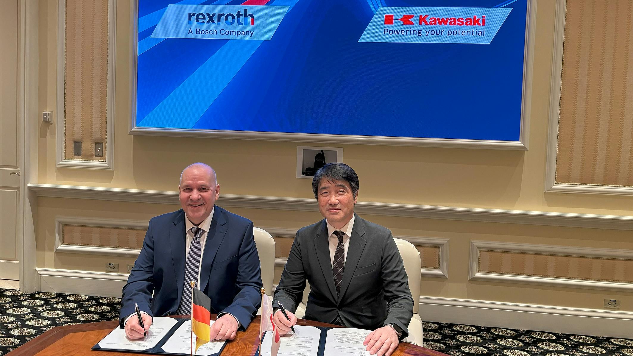Executives from Bosch Rexroth and Kawasaki Heavy Industries at signing for new tech partnership