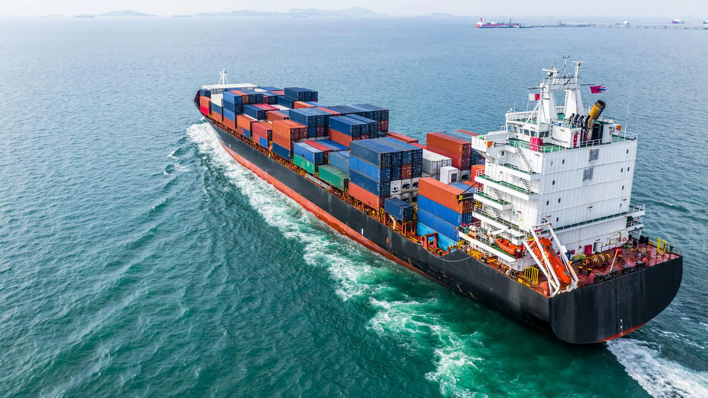 Aerial view of a cargo ship sailing through open waters