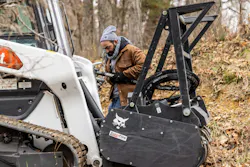 Man attaching hydraulic hoses for mulcher to a Bobcat Compact Track Loader Man attaching hydraulic hoses for mulcher to a Bobcat Compact Track Loader