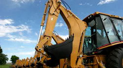 Back view of several backhoes lined up Back view of several backhoes lined up