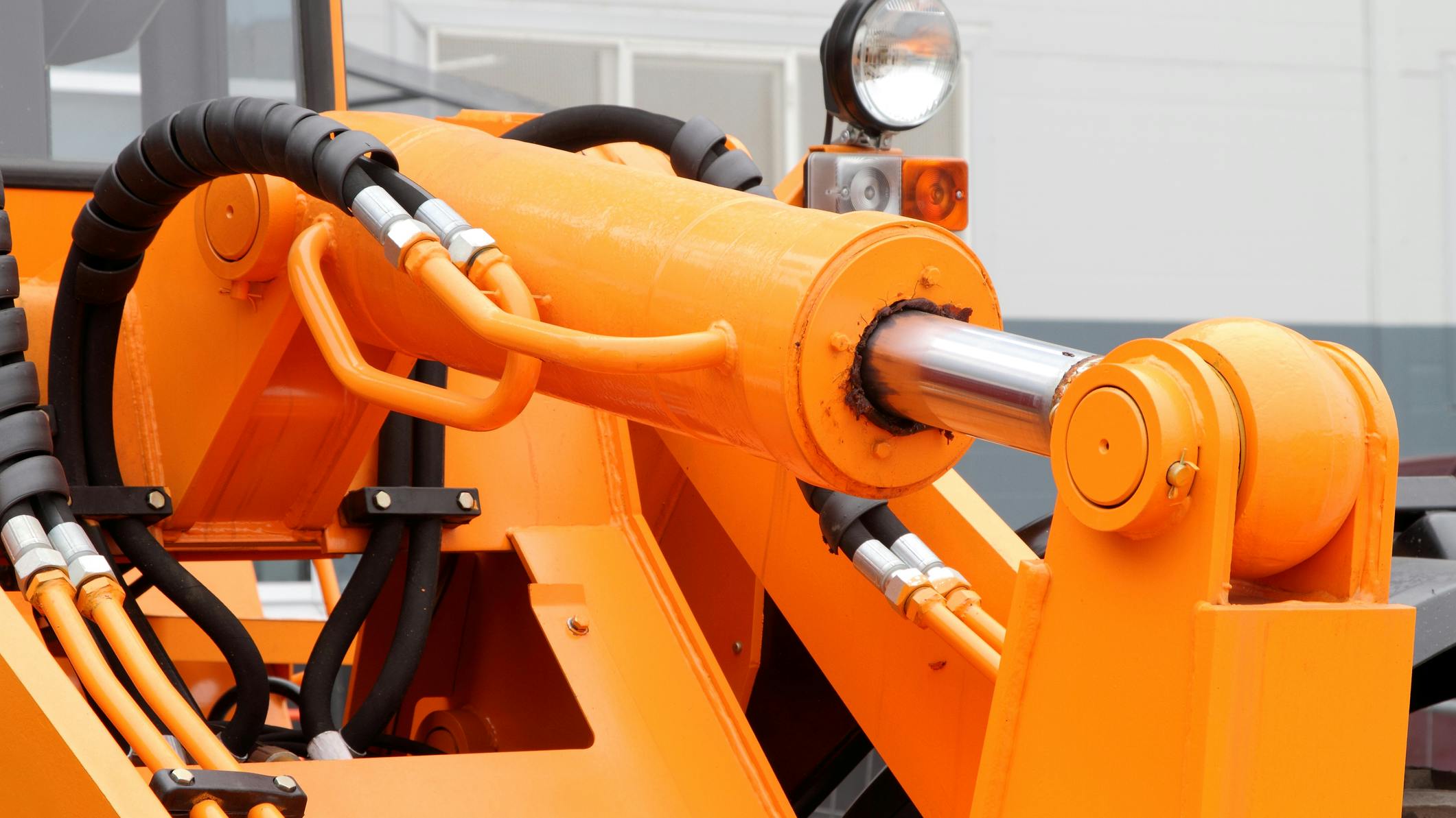 Close up view of hydraulic cylinder and hoses on a tractor