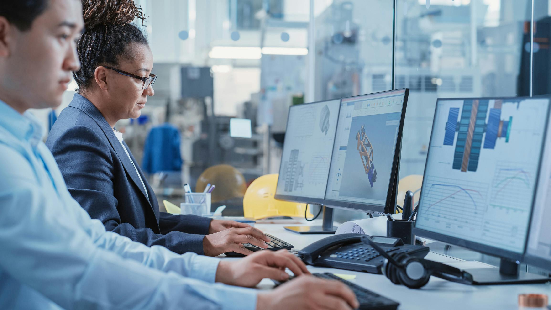 Two engineers working on product design on computers