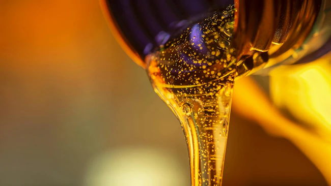 Oil Being Poured from a Bottle