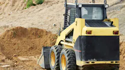 Skid steer approaching a dirt pile Skid steer approaching a dirt pile