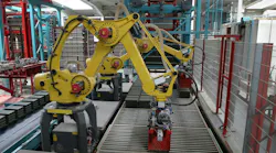 Two industrial robots working along a production line Two industrial robots working along a production line