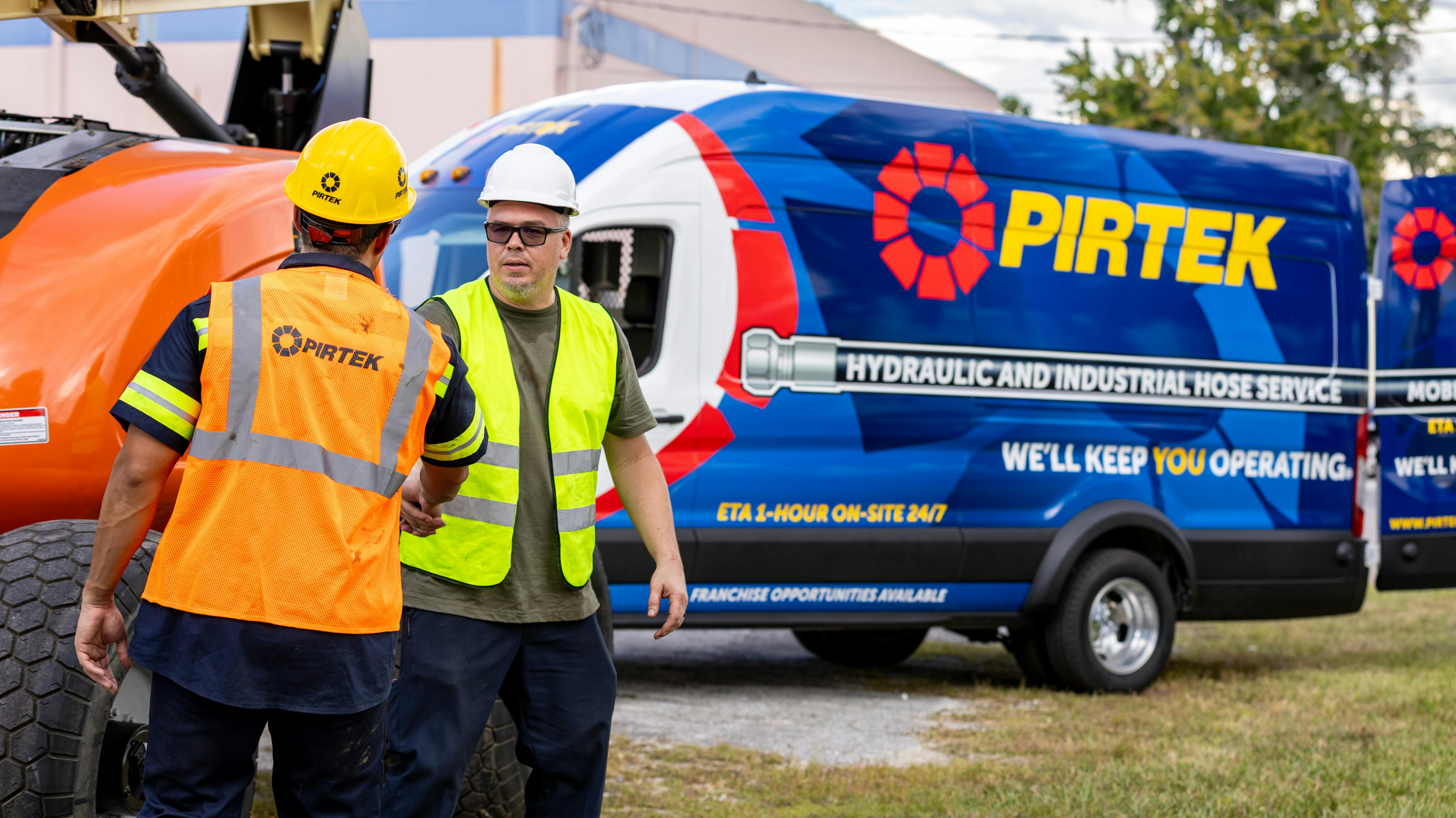 A PIRTEK service provider greeting a customer